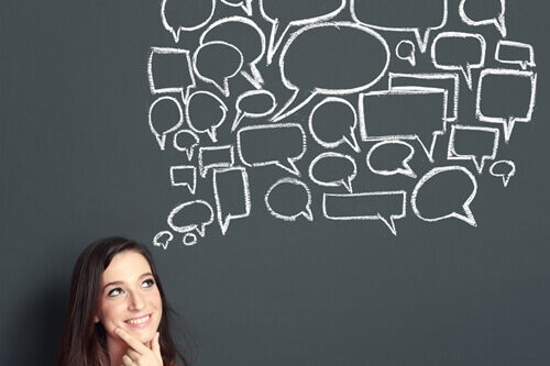 women in front of chalkboard with speech bubbles building personal brand
