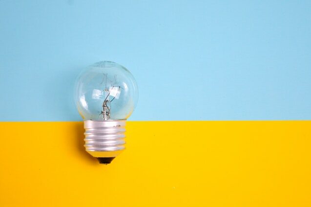 light bulb against blue and yellow background