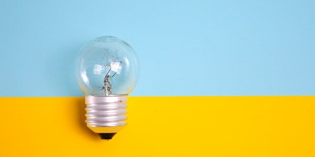 light bulb against blue and yellow background