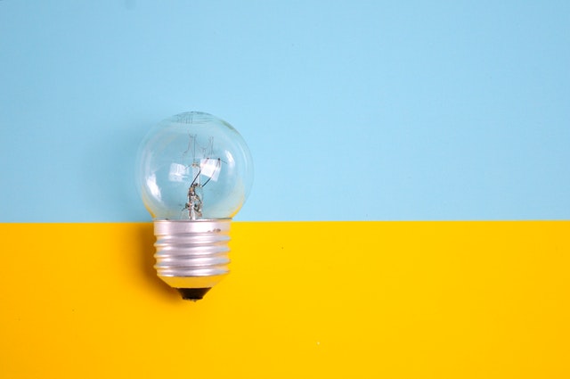 light bulb against blue and yellow background